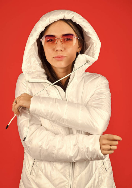 Pink eyeglasses. Keep calm and wear cool glasses. Cute Pretty girl hood jacket red background. Fashion has to reflect who you are. Woman enjoy spring weather. Woman fashion model. Fashion outfit - Fotó, kép