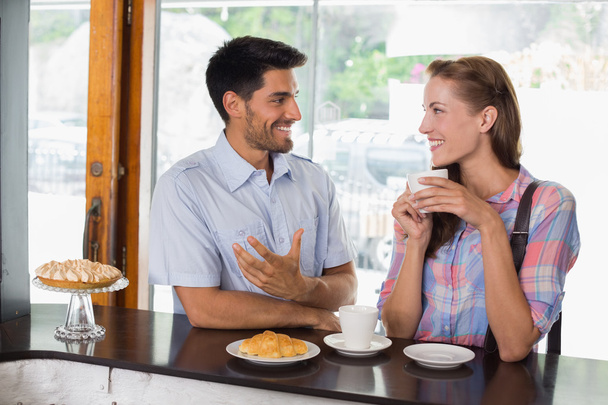 Smiling couple with coffee and croissant at coffee shop - Foto, immagini