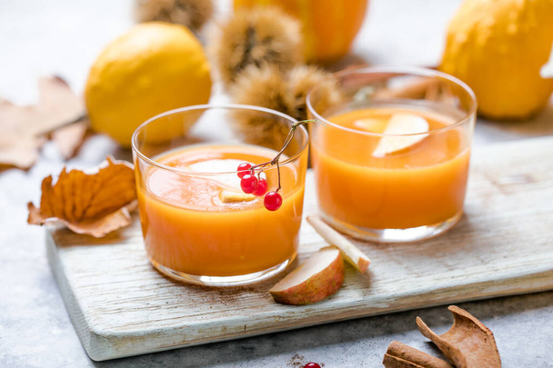 hot pumpkin punch or sangria in a glass with apple. Halloween and Thanksgiving beverage. Traditional autumn, winter drinks and cocktails - 写真・画像