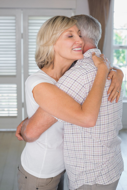Mature couple embracing at home - Photo, Image