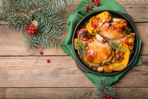 Roasted Christmas Chicken  thighs with pumpkin   for Christmas Dinner. Festive decorated wooden table. Festive decorated wooden table for Christmas Dinner with baked chicken - Zdjęcie, obraz
