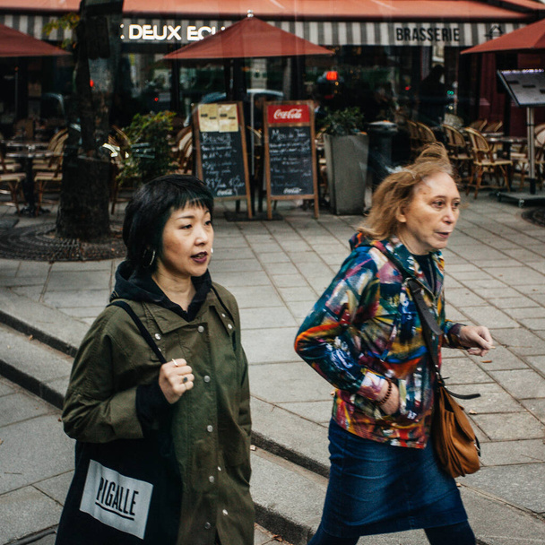 PARIS, FRANCE - October 7, 2016: Citizens walk past a streets,  cafeterias  and stores  on October 7, 2016  in Paris.  Paris street life in daytime - 写真・画像