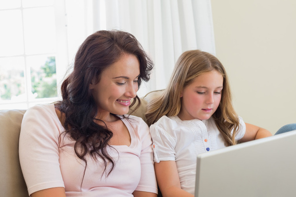 Mother and daughter using laptop - Foto, imagen