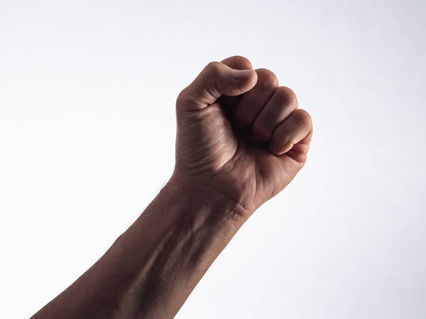 Fingers folded into a fist on a white background. - Foto, Bild