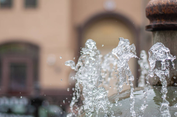 Woda tryskająca z ulicznej fontanny. Odrobina wody w fontannie, abstrakcyjny obraz.. - Zdjęcie, obraz