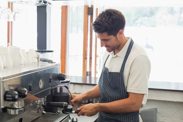 Smiling barista preparing espresso at coffee shop - 写真・画像