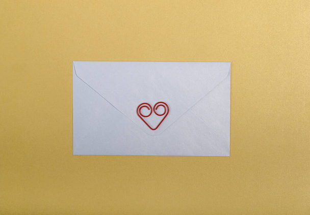 Minimalistic Christmas collage: white envelope and red heart. New year decoration. - Fotoğraf, Görsel