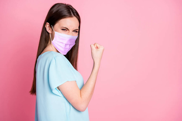 Turned photo of delighted girl raise fists wearing purple face mask isolated over pastel color background - Foto, afbeelding