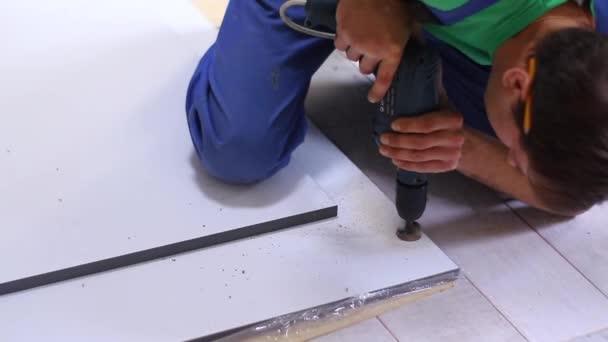 process of apartment renovation. drilling holes in furniture by fettler. sawdust scatter. unrecognizable men. remodeling, doing repairs. FullHD footage - Footage, Video