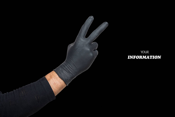 Male hand in black rubber glove showing fingers doing victory sign, Number two, symbol, v-sign or gesture. Hand doing gesture of number Two, sign language good  isolated on black background. Studio shot - Photo, Image
