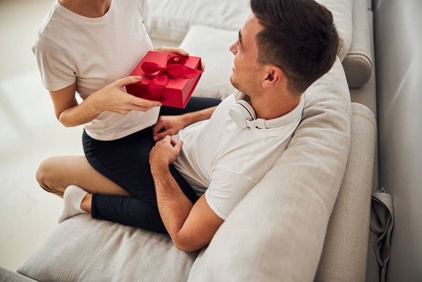 Young husband receiving the gift from his wife - Foto, Imagem