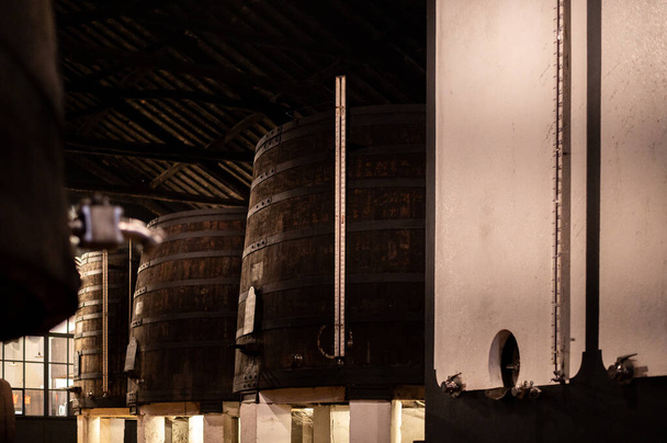 Old porto lodge with rows of concrete vats of fortified ruby or tawny porto wine in Vila Nova de Gaia, Portugal, north of Portugal - Photo, Image