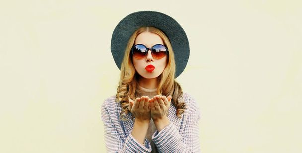 portrait of young woman blowing red lips sending sweet air kiss over background - Fotografie, Obrázek