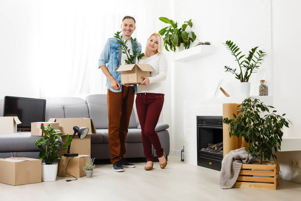 Happy young couple moving in new house - Photo, Image