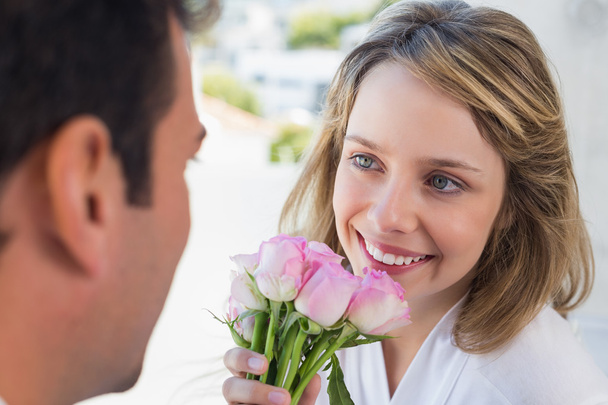 Close-up of man giving happy woman flowers - Фото, изображение