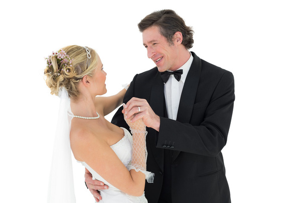 Bride and groom dancing over white background - Zdjęcie, obraz
