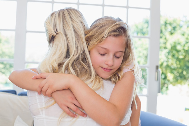 Girl with eyes closed hugging mother - Photo, Image