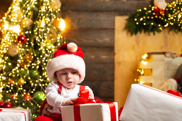 Portrait of baby in Santa clothes and Christmas hat. - Фото, изображение