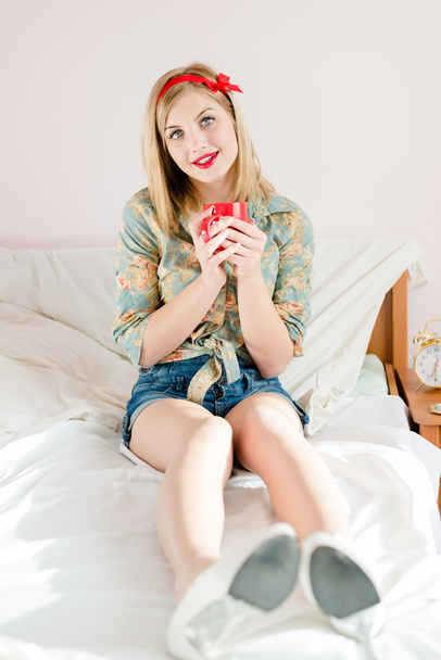 Girl holding cup of hot drink - Fotó, kép