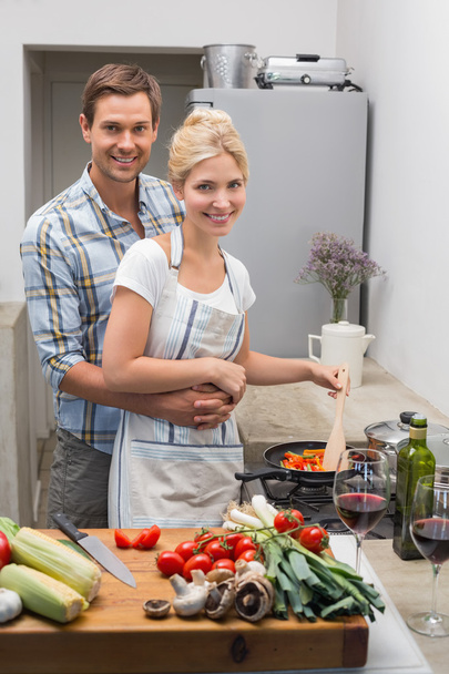 Young couple preparing food together in the kitchen - Photo, Image