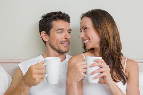 Happy relaxed couple with coffee cups - Фото, изображение
