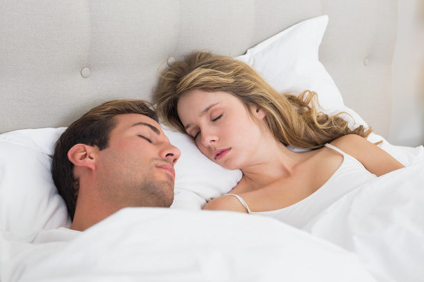 Relaxed couple sleeping together in bed - Fotoğraf, Görsel