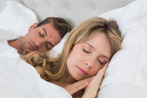 Relaxed couple sleeping together in bed - Foto, immagini