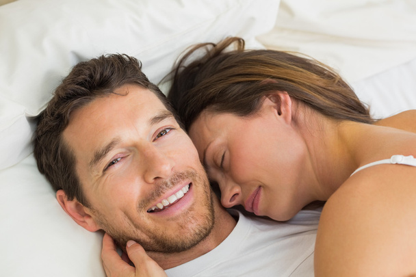 Close-up of a loving couple lying in bed - Foto, Imagen