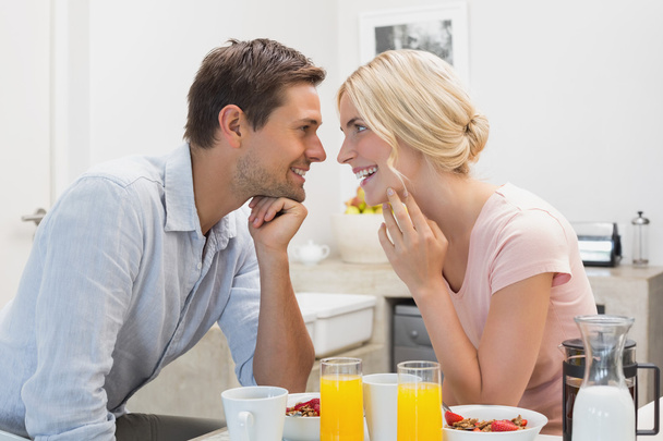 Happy couple having breakfast at home - Фото, зображення