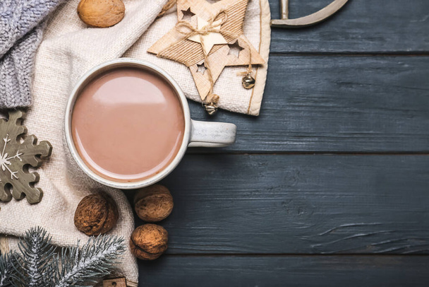 Cup of hot cacao drink with Christmas decorations on dark wooden background - Foto, Imagen