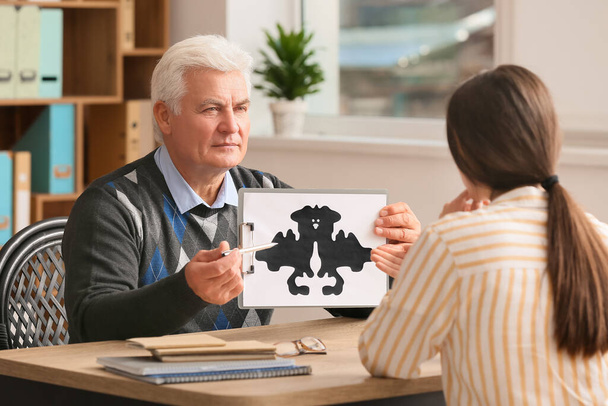 Senior male psychologist working with patient in office - Photo, Image
