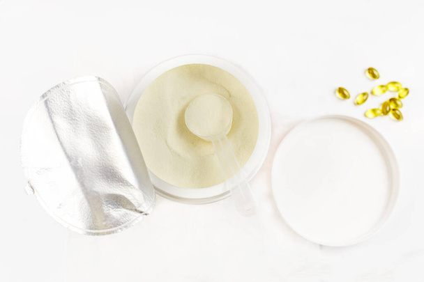cologen powder for face rejuvenation in a serving spoon on a white background - Φωτογραφία, εικόνα