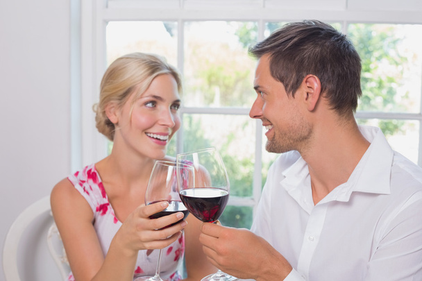 Loving couple with wine glasses looking at each other - Valokuva, kuva