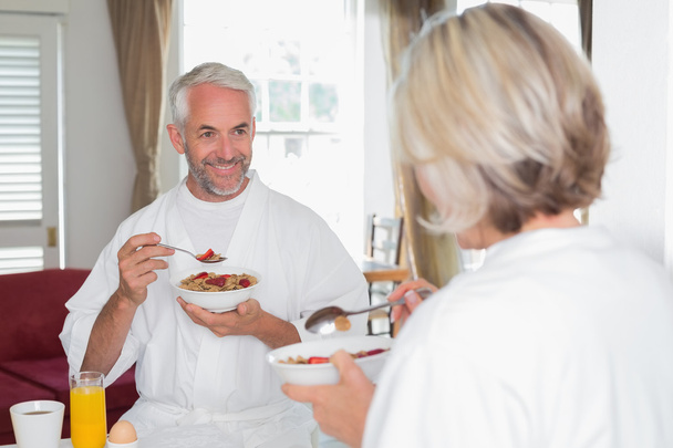 Mature man having breakfast with cropped woman at home - Фото, изображение