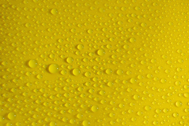 natural water drops on yellow background texture - Valokuva, kuva