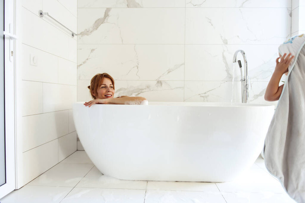Woman lying in a bubble bath  - Fotoğraf, Görsel