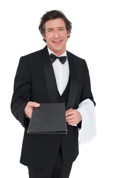 Confident waiter giving bill pad over white background - Foto, afbeelding