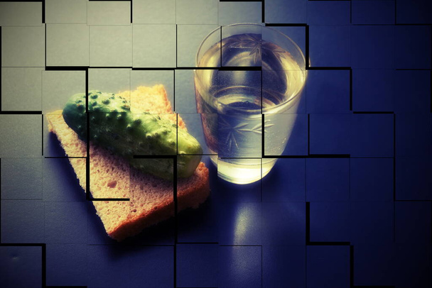 alcoholism. social problems loneliness. glass of vodka bread and pickle on a dark background. a picture falling to pieces. double vision strong intoxication - Photo, Image