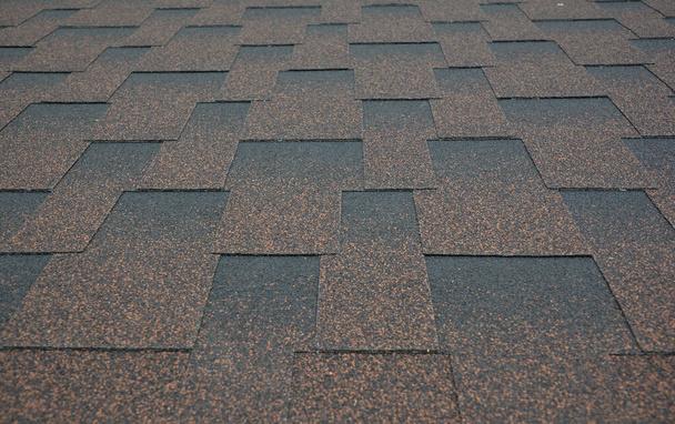 Asphalt shingles textured background. A close-up on copper brown dimensional, or architectural roofing asphalt shingles background. - Photo, Image