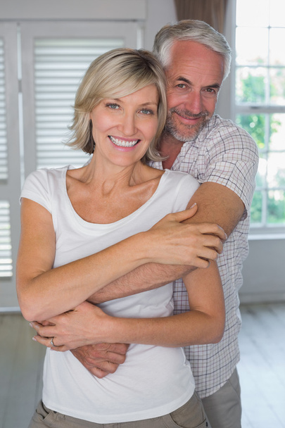 Mature man embracing woman from behind - Photo, Image