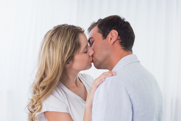 Close-up side view of a loving couple kissing - Photo, Image
