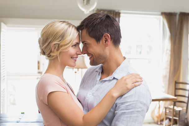 Loving couple looking at each other at home - Foto, imagen