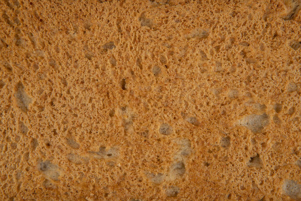 The texture of a slice of bread - top view and a close-up of a piece of a slice of bread - Photo, Image