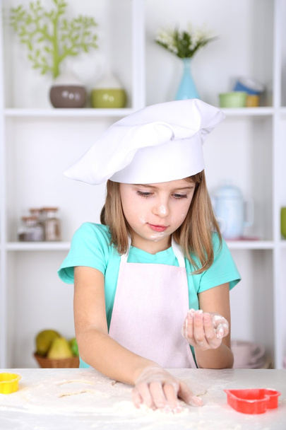 Little girl preparing cookies in kitchen at home - Foto, Imagem