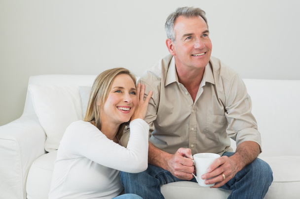 Couple with coffee cup in living room - Foto, imagen