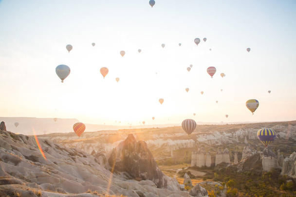 Balloons at dawn in the landscape of cappadocia - Фото, изображение