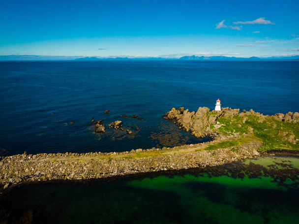 Scenic seascape with lighthouse at Hovsund fishing port, Gimsoya Lofoten Islands in Norway - 写真・画像