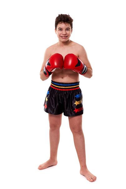 Young kickboxing fighter in red gloves with various strikes posing on white background - Fotoğraf, Görsel