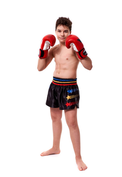 Young kickboxing fighter in red gloves with various strikes posing on white background - Φωτογραφία, εικόνα