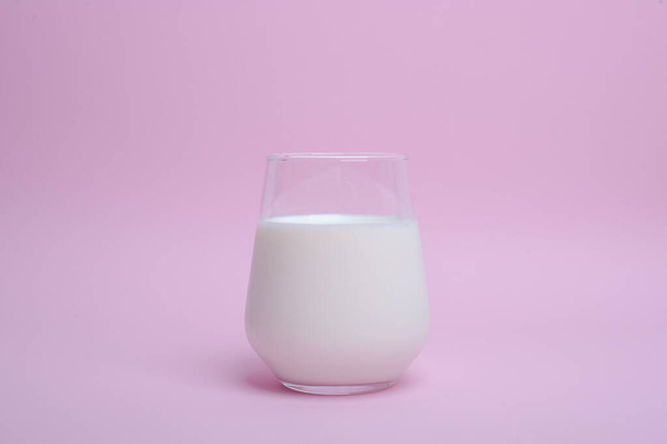 glass with milk on a pink background - Photo, image